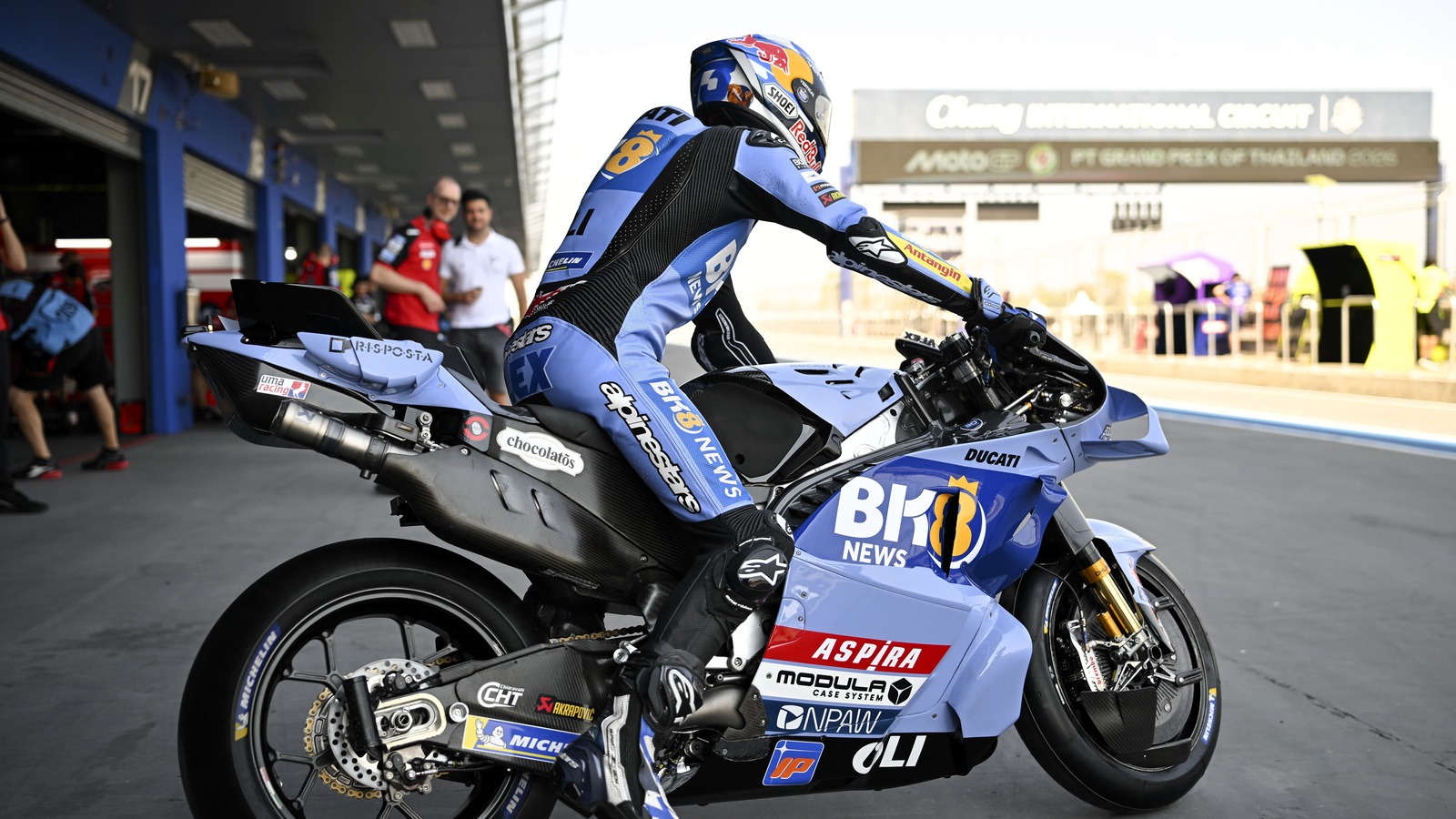 Marco Bezzecchi celebrating on the podium after winning the 2026 Thai Grand Prix at Buriram, holding the winner's trophy…