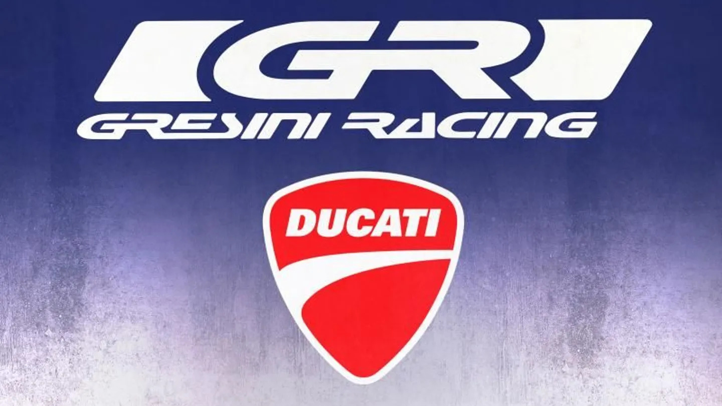 Wide shot of the Gresini Honda garage showing team engineers, motorcycles on stands and factory equipment during preparation