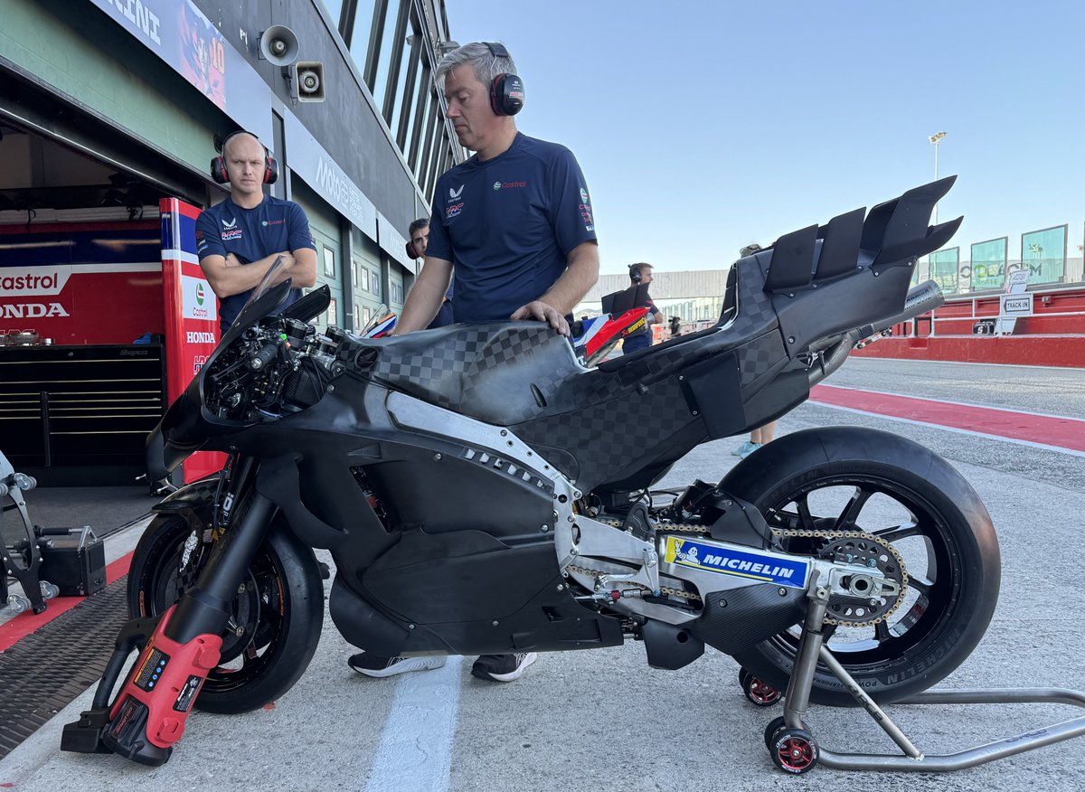 Honda RC213V leaning through a fast corner on track showing rider posture and bike motion