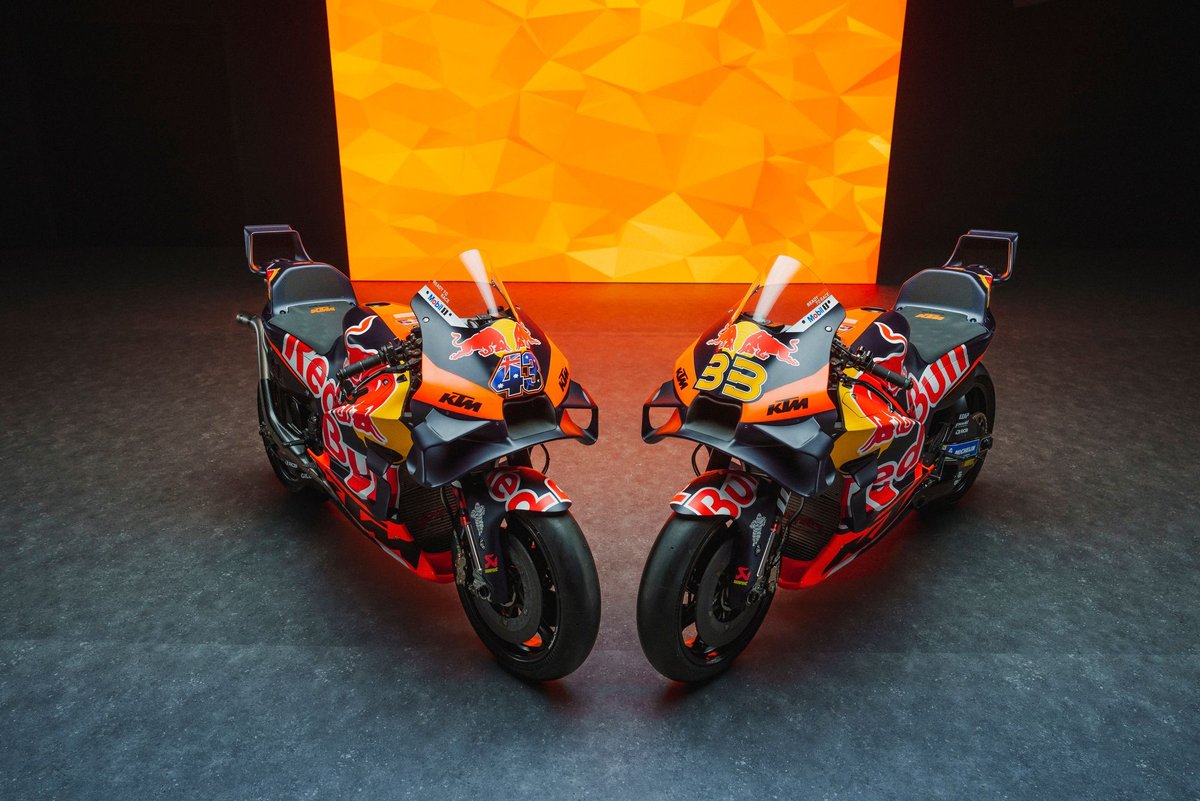 KTM MotoGP prototype undergoing testing with engineers observing data at the circuit pit lane