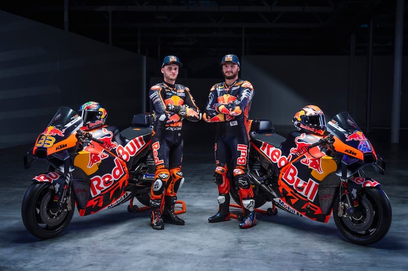 KTM MotoGP bike on track during the team's debut season, rider leaning into a corner with vibrant orange livery