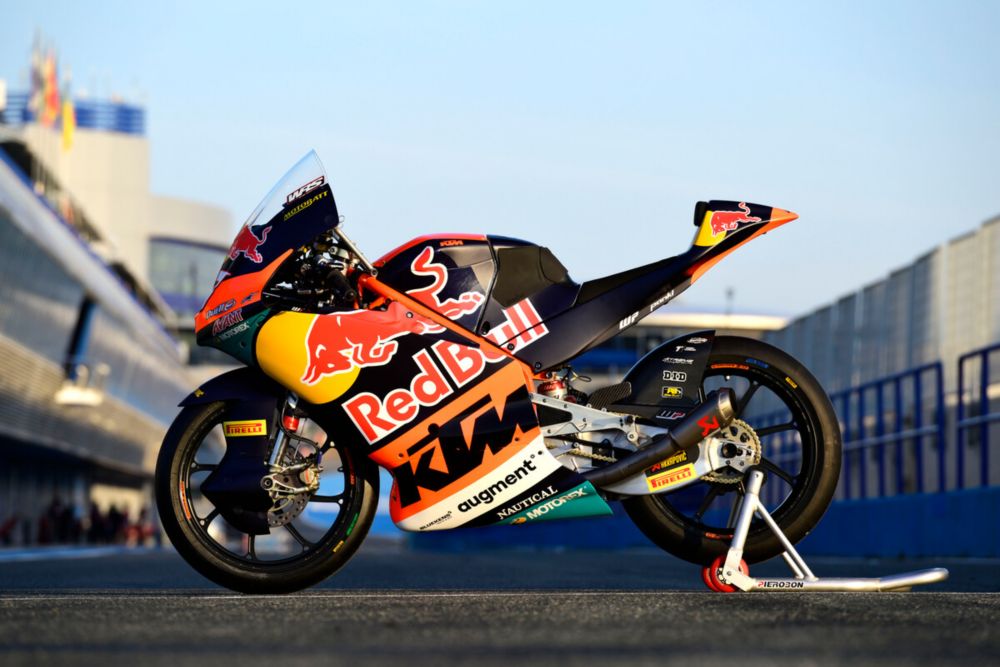 KTM MotoGP bike leaning deeply in a fast corner with visible rear tire grip tension