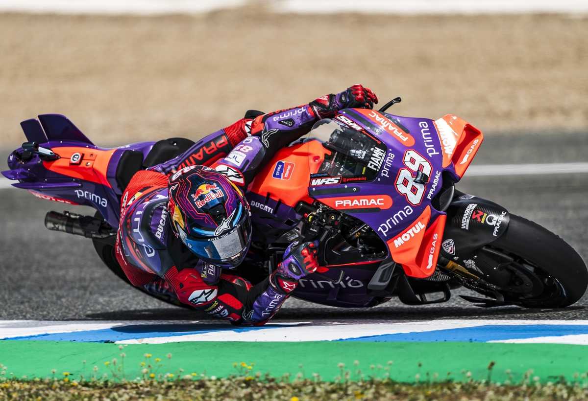 Jorge Martin crossing the finish line on his Aprilia at Le Mans with spectators in the background