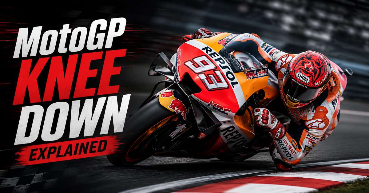 MotoGP rider leaning sharply with knee slider contacting the asphalt during a high-speed corner
